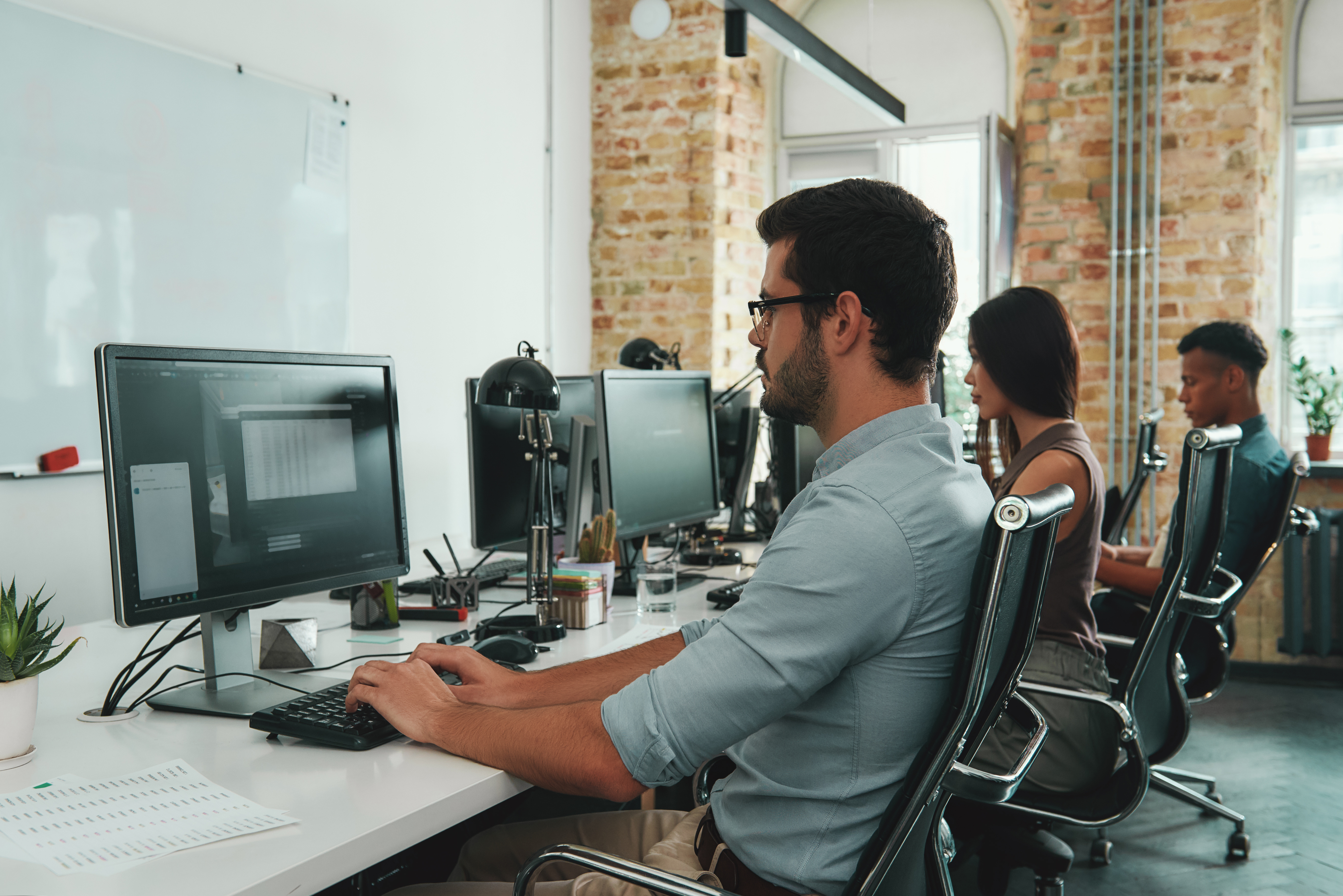 Three office workers on the computers