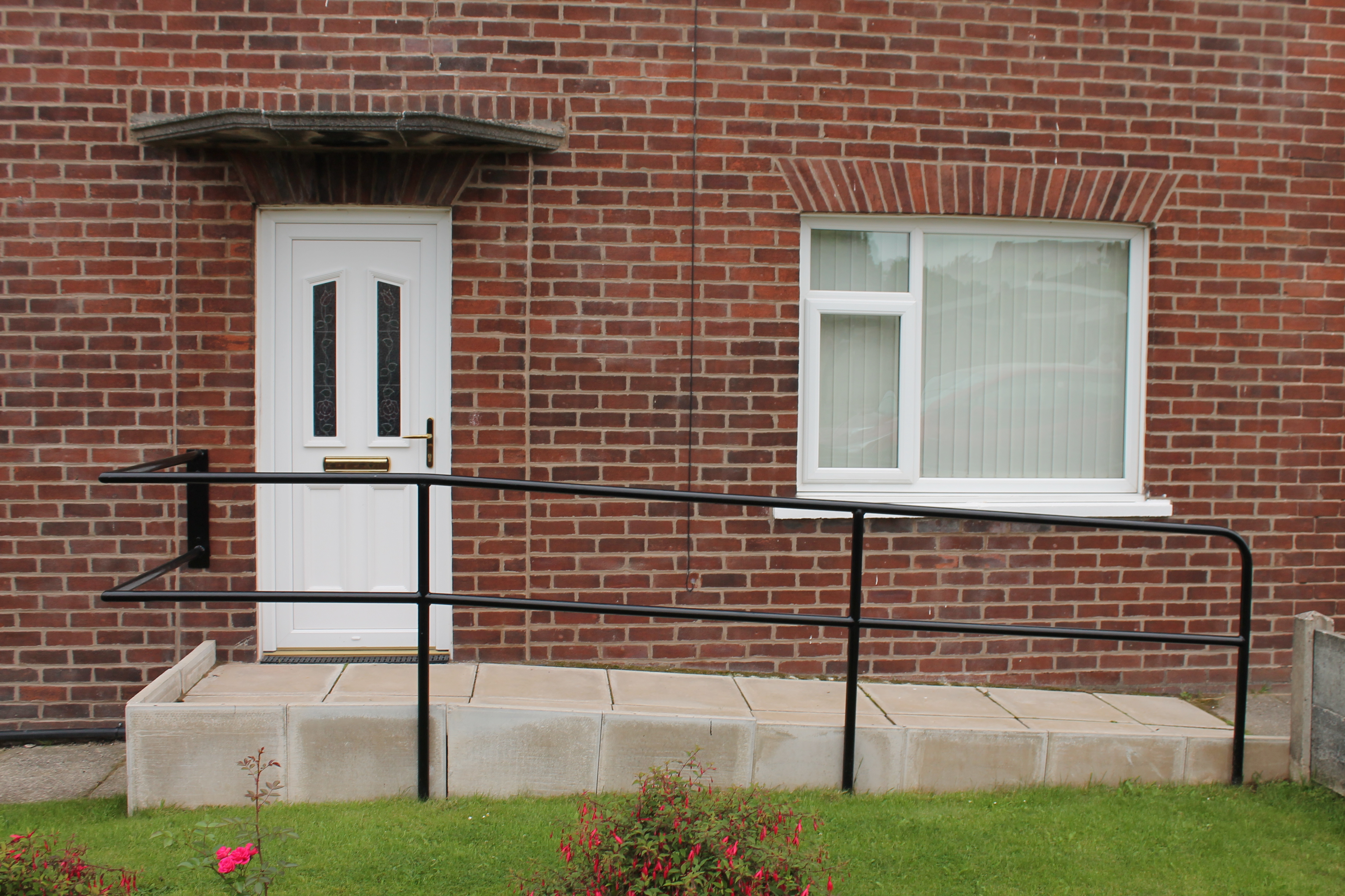Wheelchair access ramp leading to front door of a house