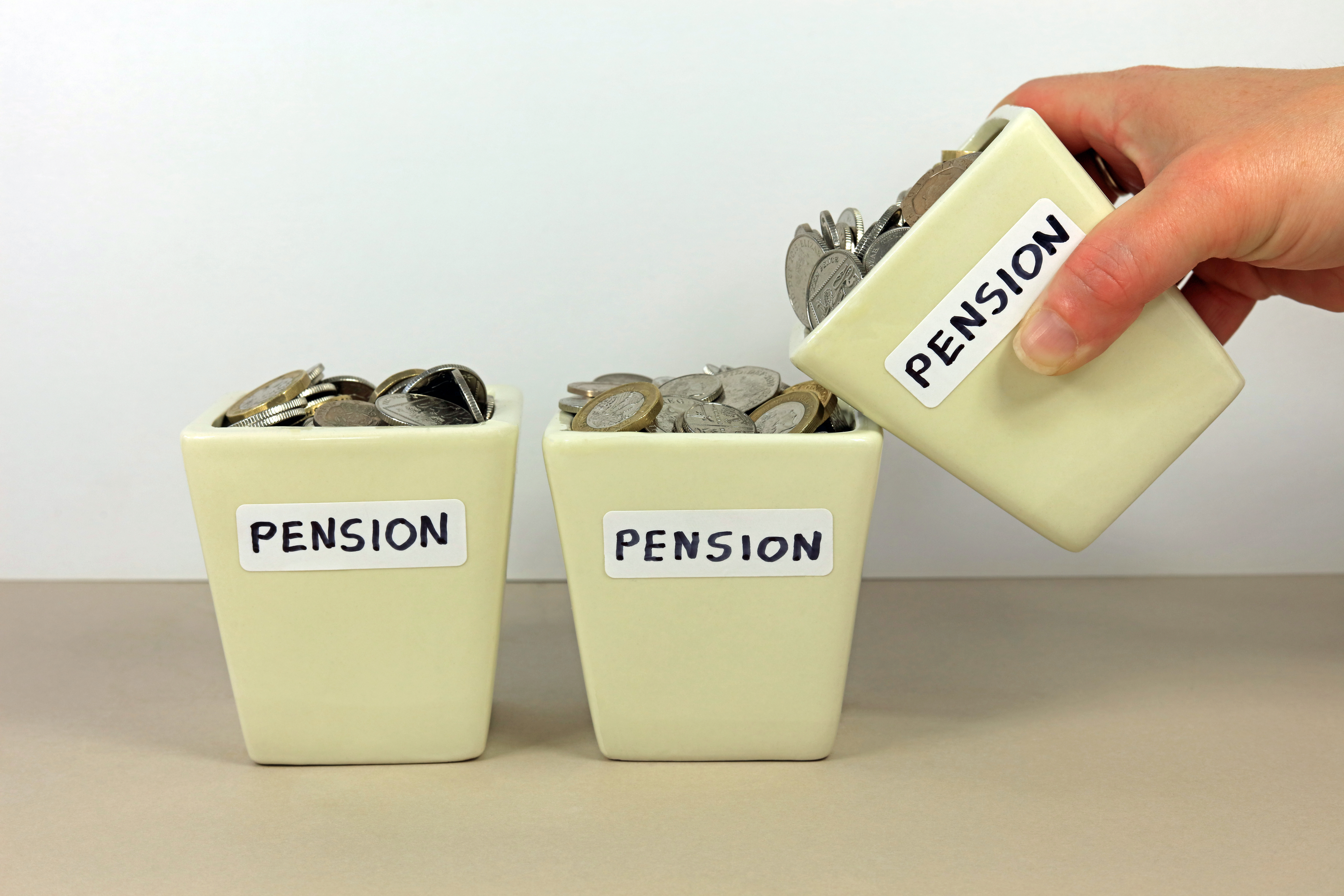 A row of three pots with money and the words Pension on them