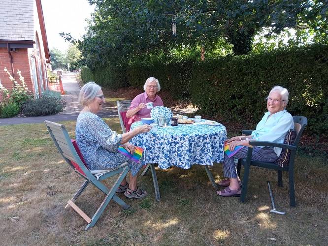Residents having tea on the lawn at Gracey Court