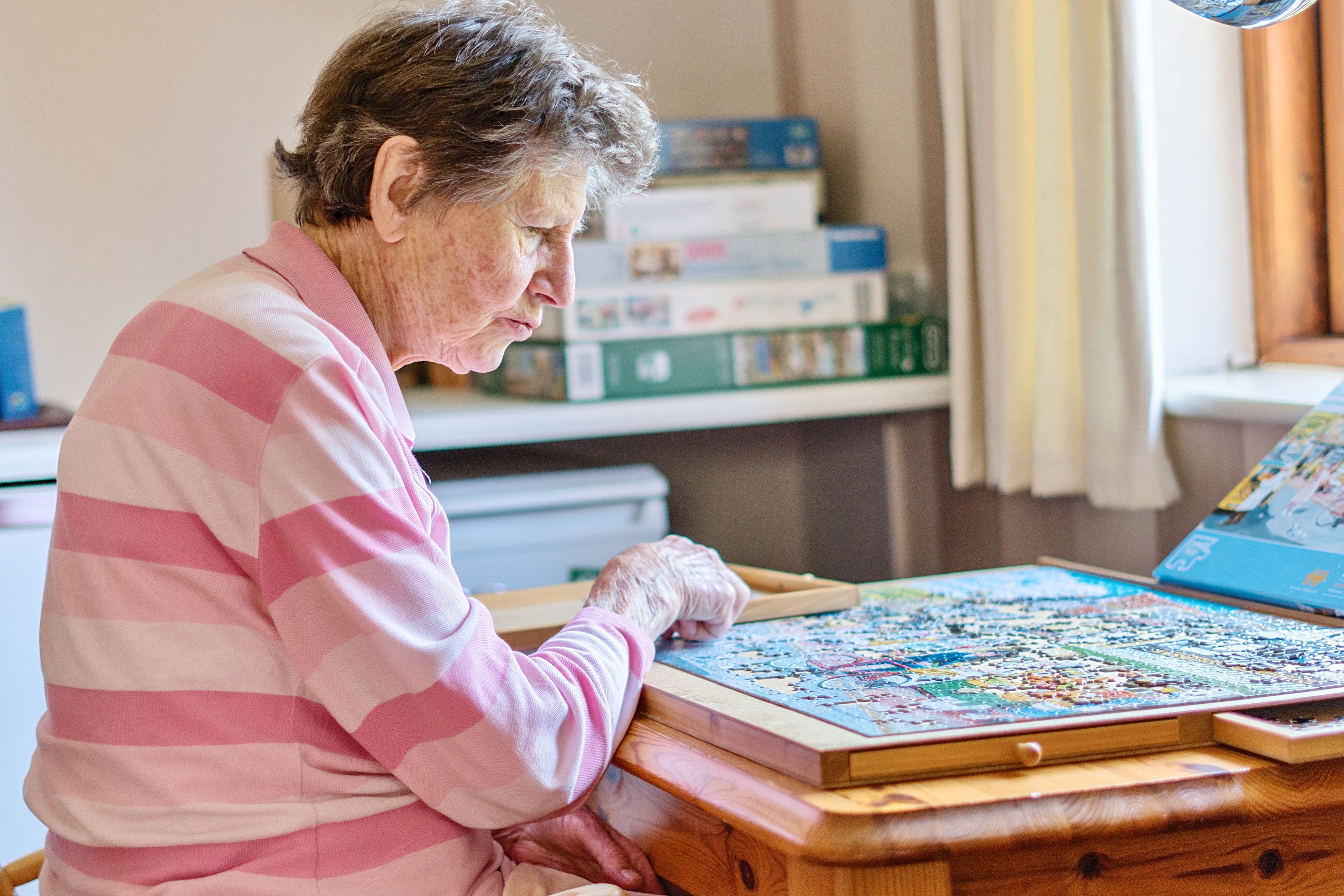 A resident at Stuart Court doing a jigsaw