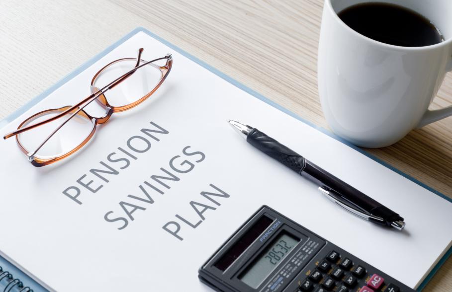 A document with the words 'Pensions Saving Plan' with glasses, pen and calculator