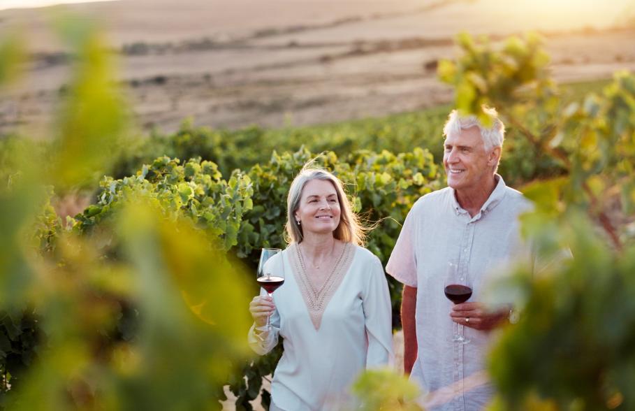 A couple in a vineyard on holiday in retriement