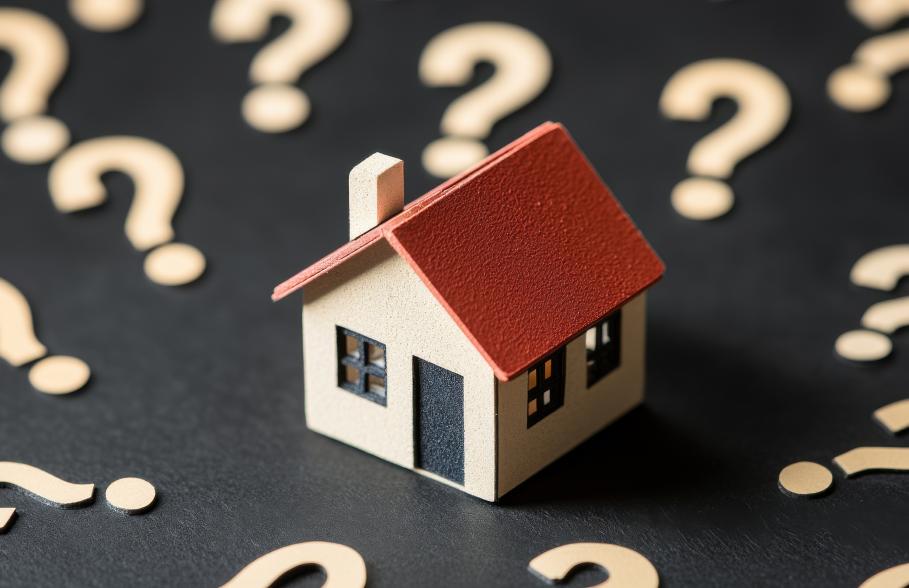 An image of a house surrounded by questions marks