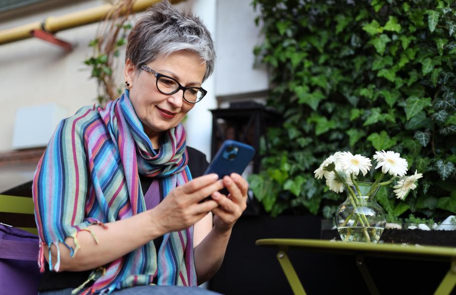 Older person on mobile phone in garden