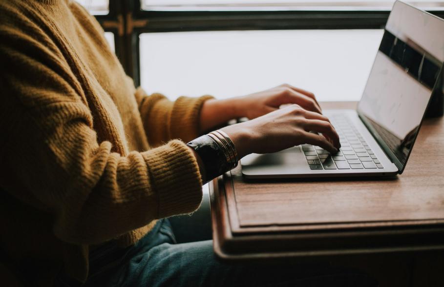 A person typing on a laptop