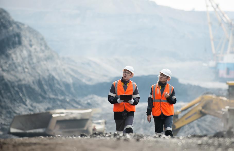 Workers with coal at open pit