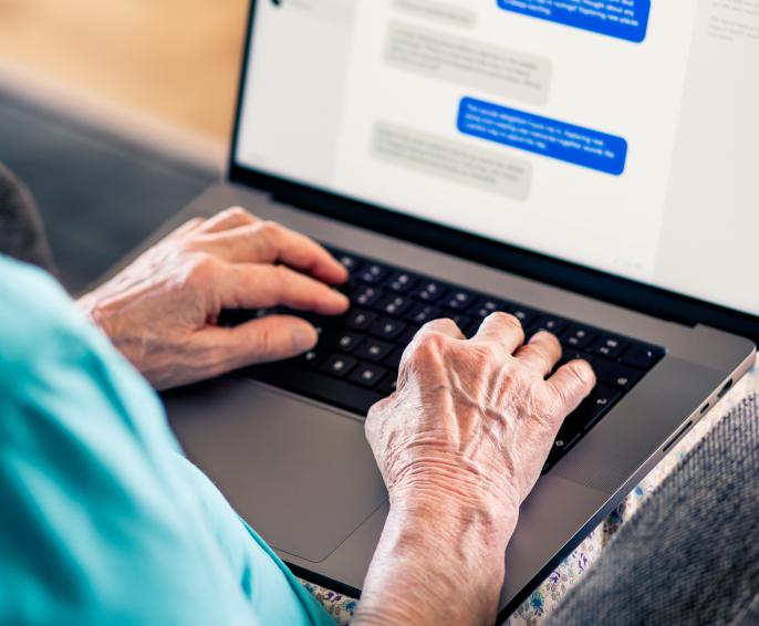 Person at laptop writing messages